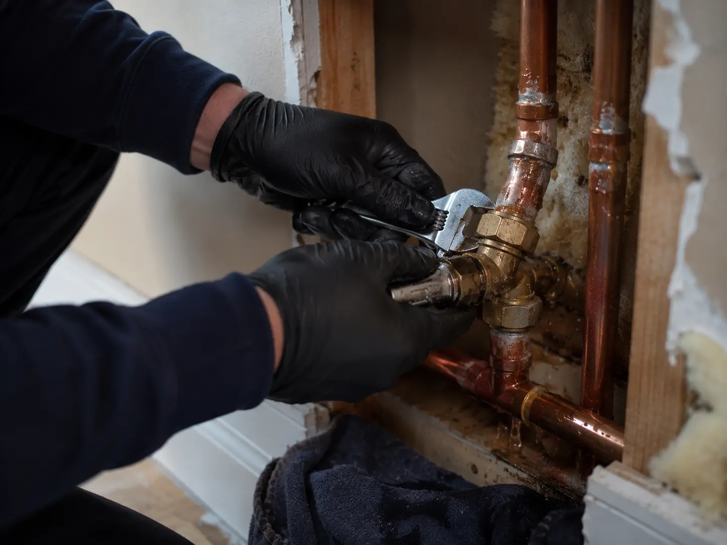 Plumber working on pipework